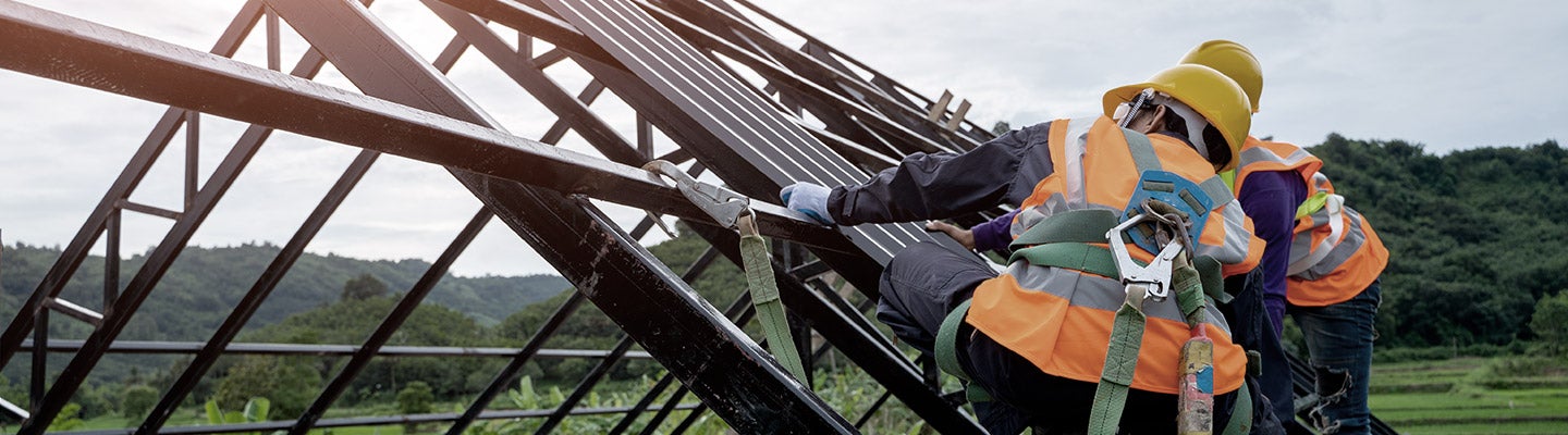 Trade workers building a roof