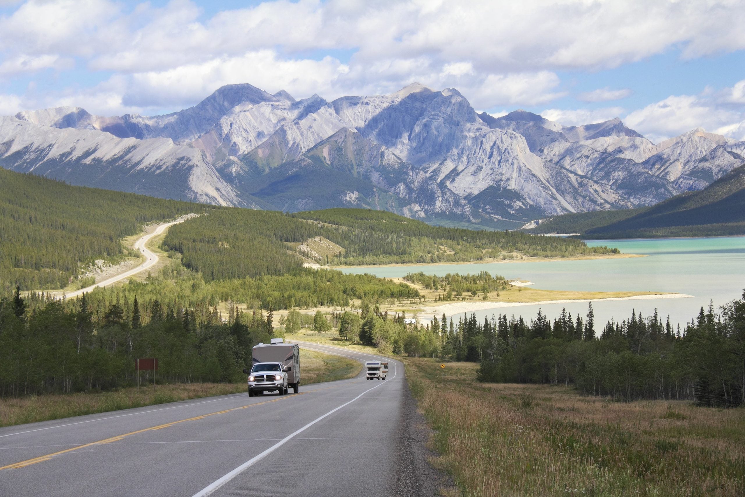 Road beside rocky mountains in Alberta