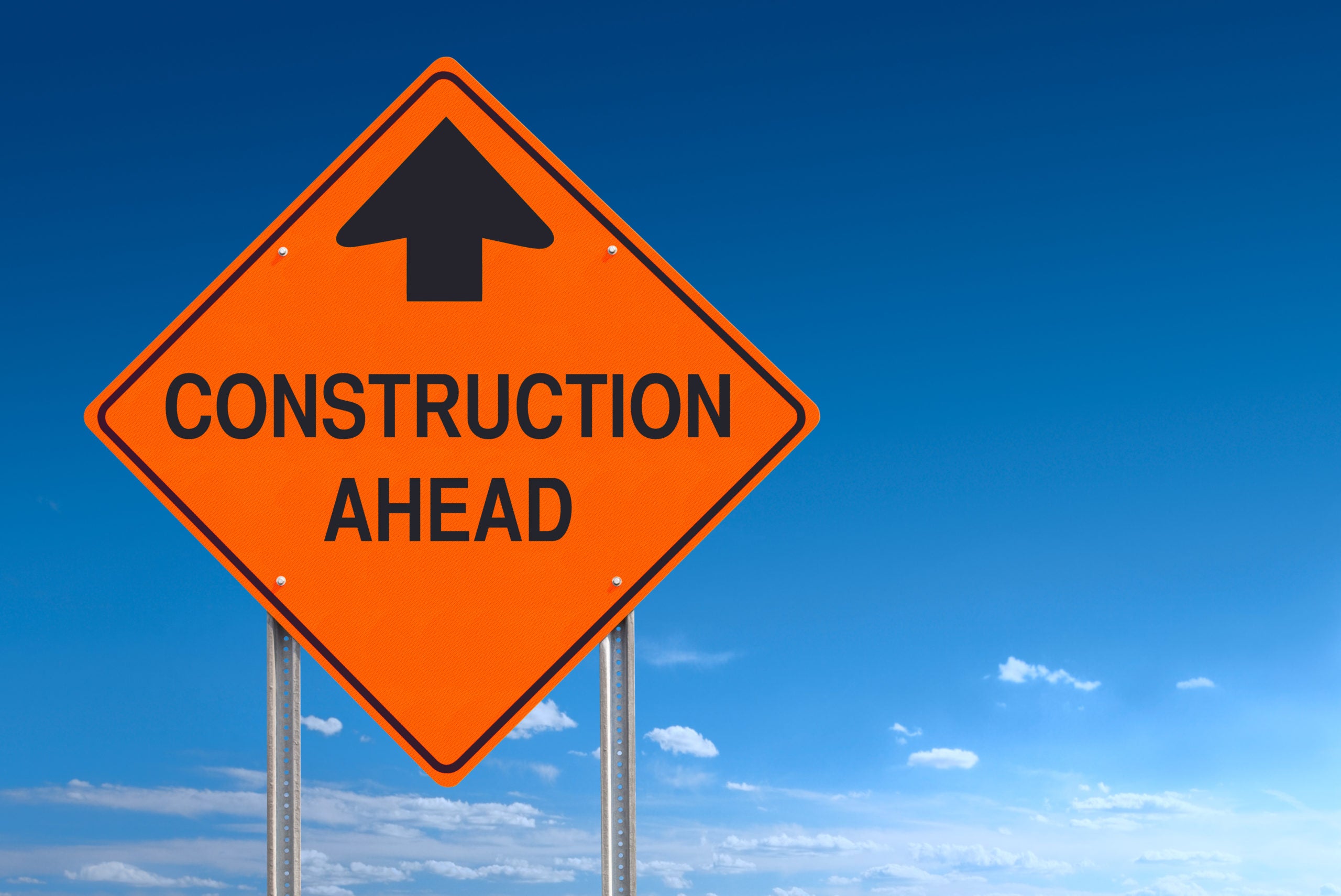 Conceptual road sign warning of construction ahead - a clipping path is included to separate sign from bkg.
