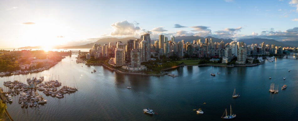 Aerial view of downtown Vancouver with False Creek in the foreground. Taken during a bright sunset.