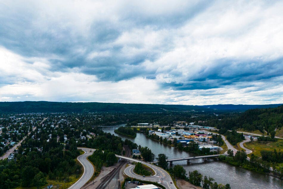 Image of the city of Prince George with a river running through the middle and a bridge overtop.