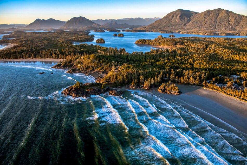 Aerial shot of a beach on Vancouver Island with waves coming in.