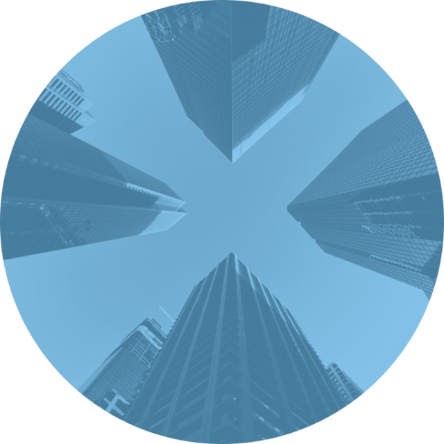 View from the ground up of four skyscrapers against the sky