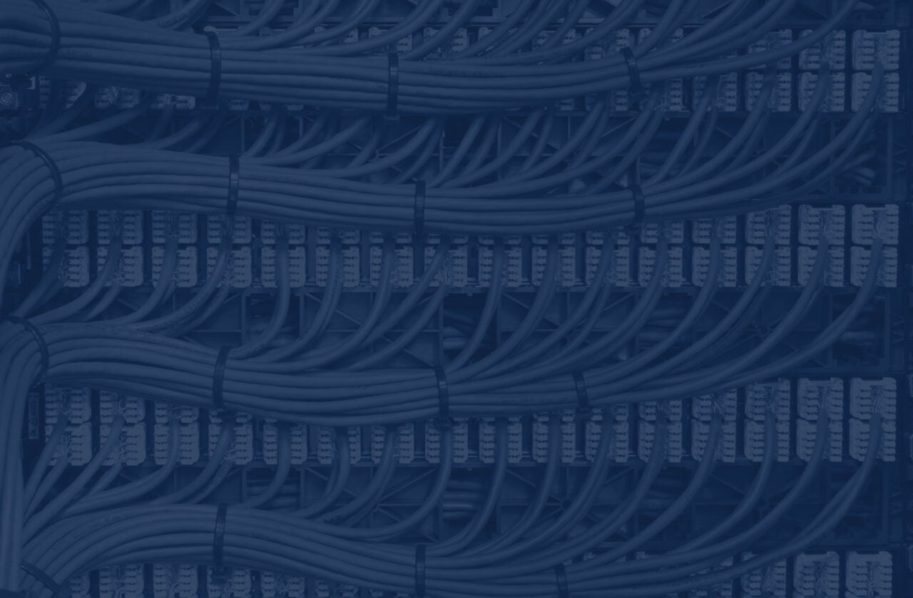 Blue network cables neatly channelled into their specified ports.