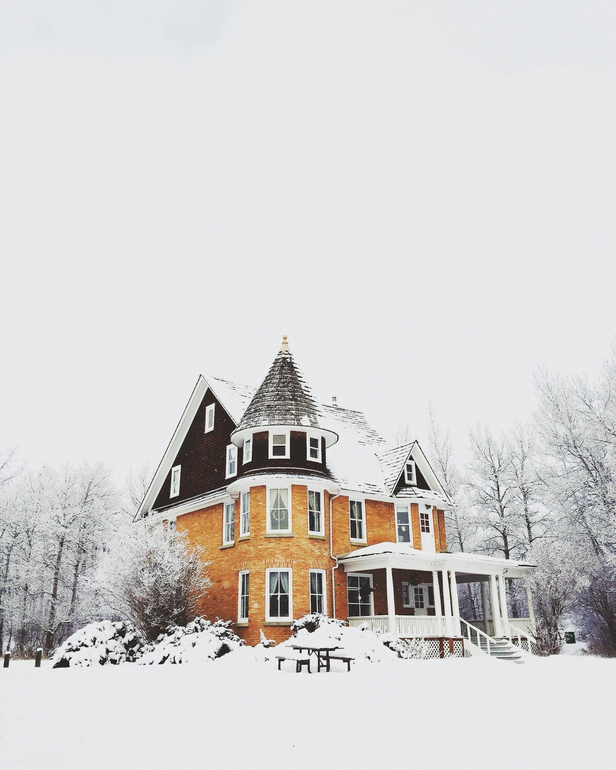 House with tall peaks in the winter covered in snow