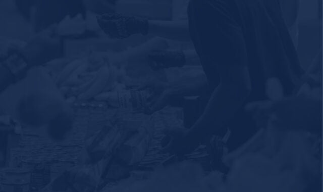 non-profit workers at a food bank serving meals, with a navy overlay