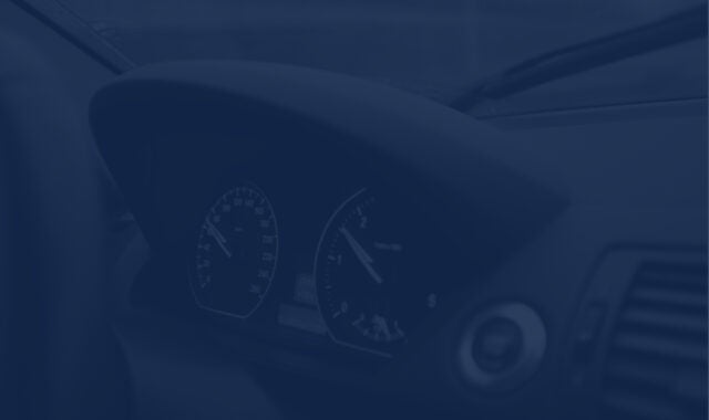 a closeup of a car dash with speedometer and other dials