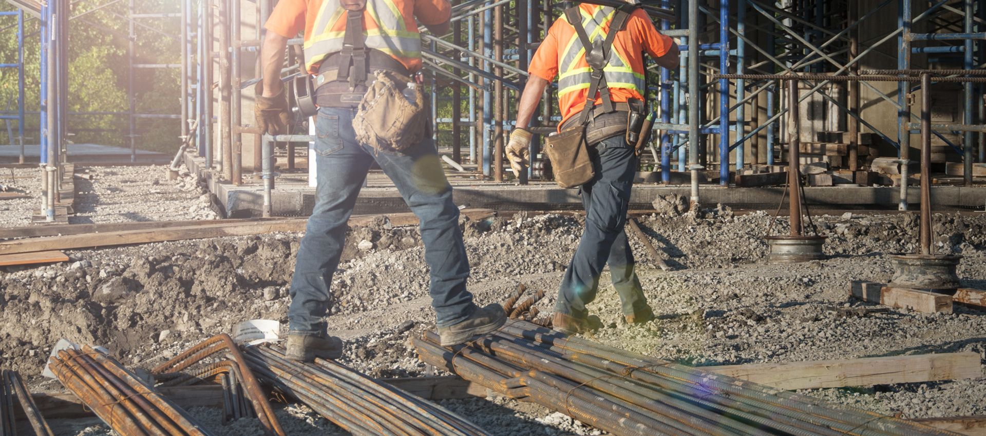 Two construction workers walking on site