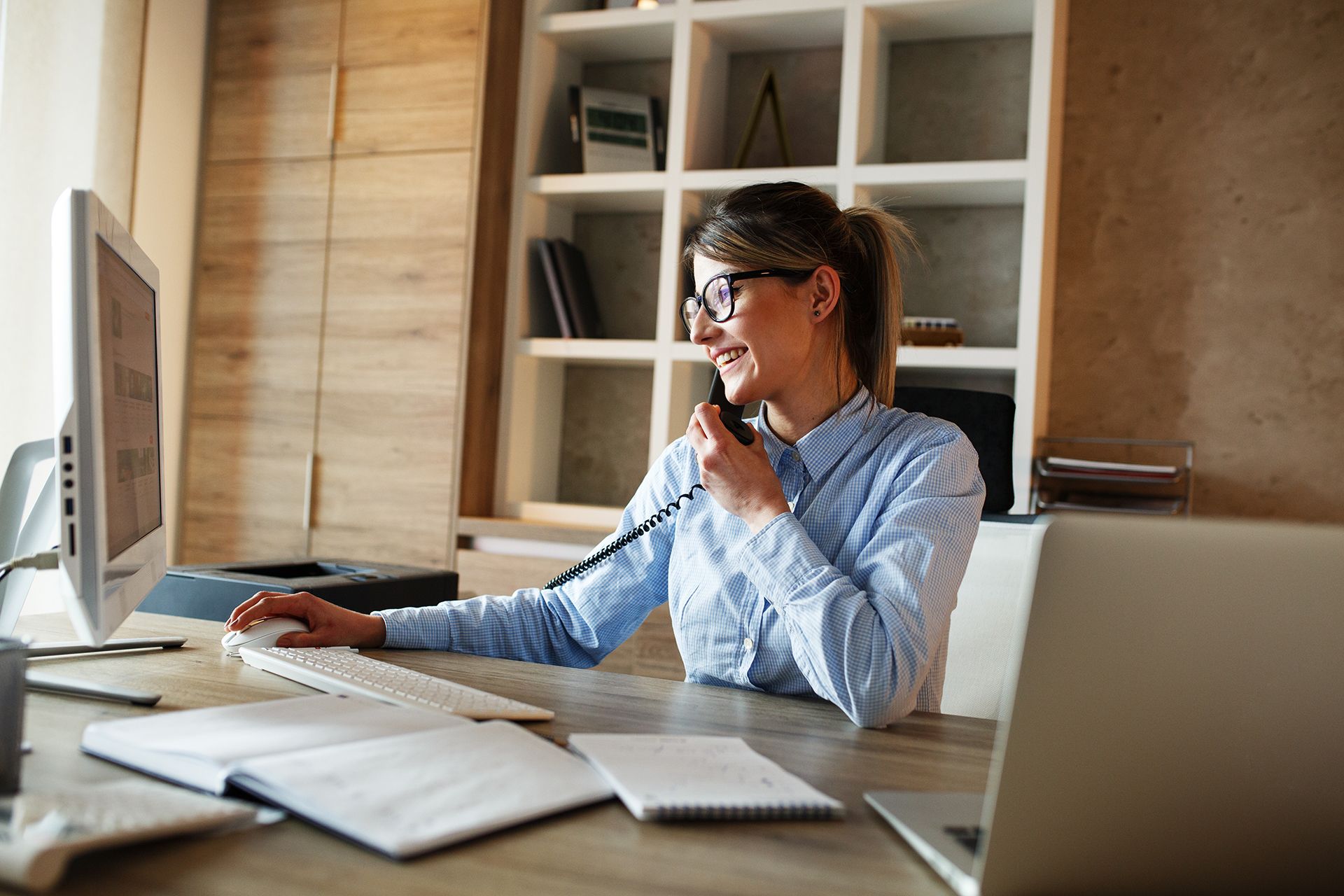 Woman working in office on phone