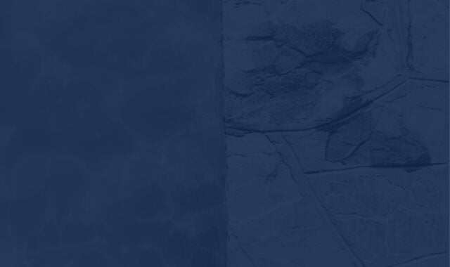 a close up of a pool with water and stone