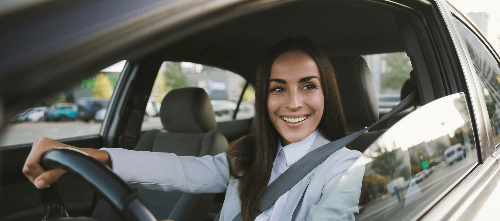 Woman driving car and smiling