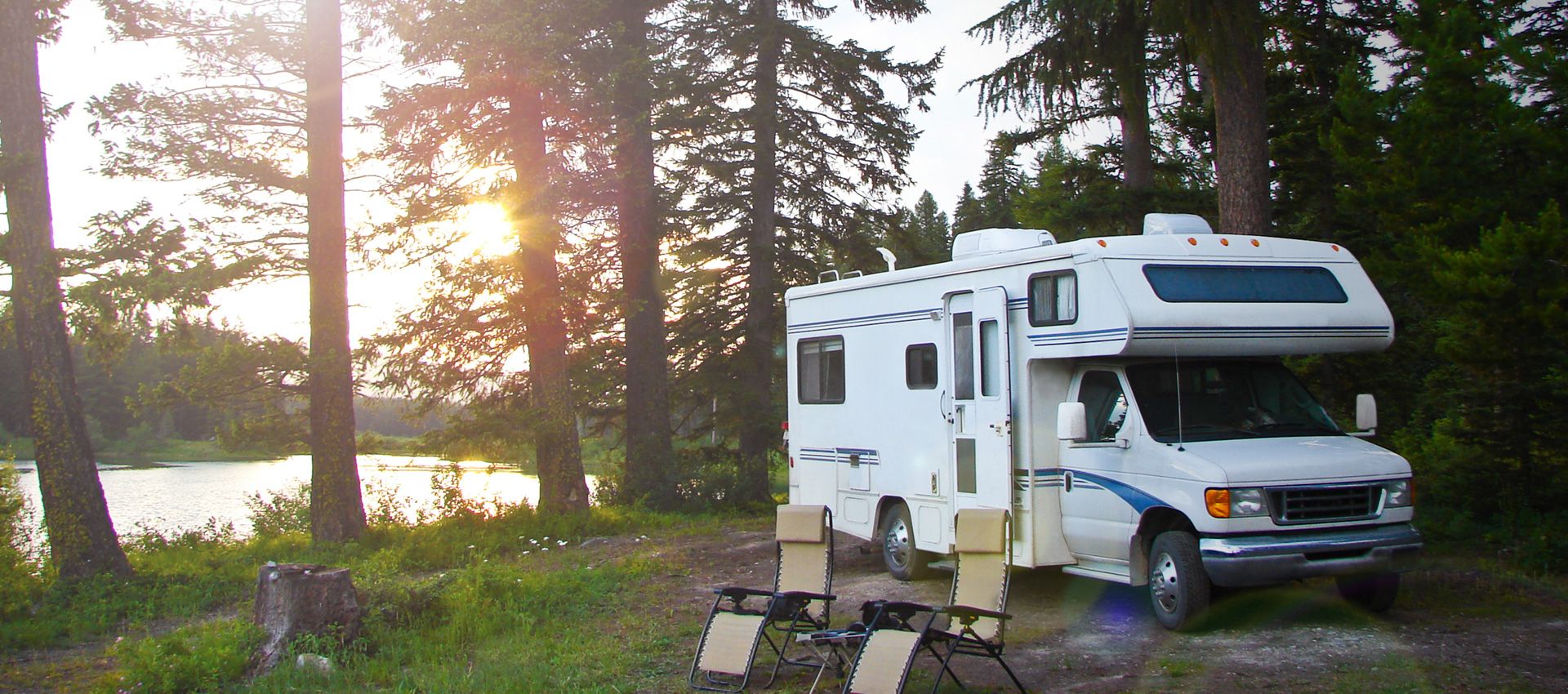 RV parked at a camp site at dusk