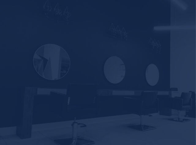 Row of 3 chairs and 3 mirrors in a hair salon