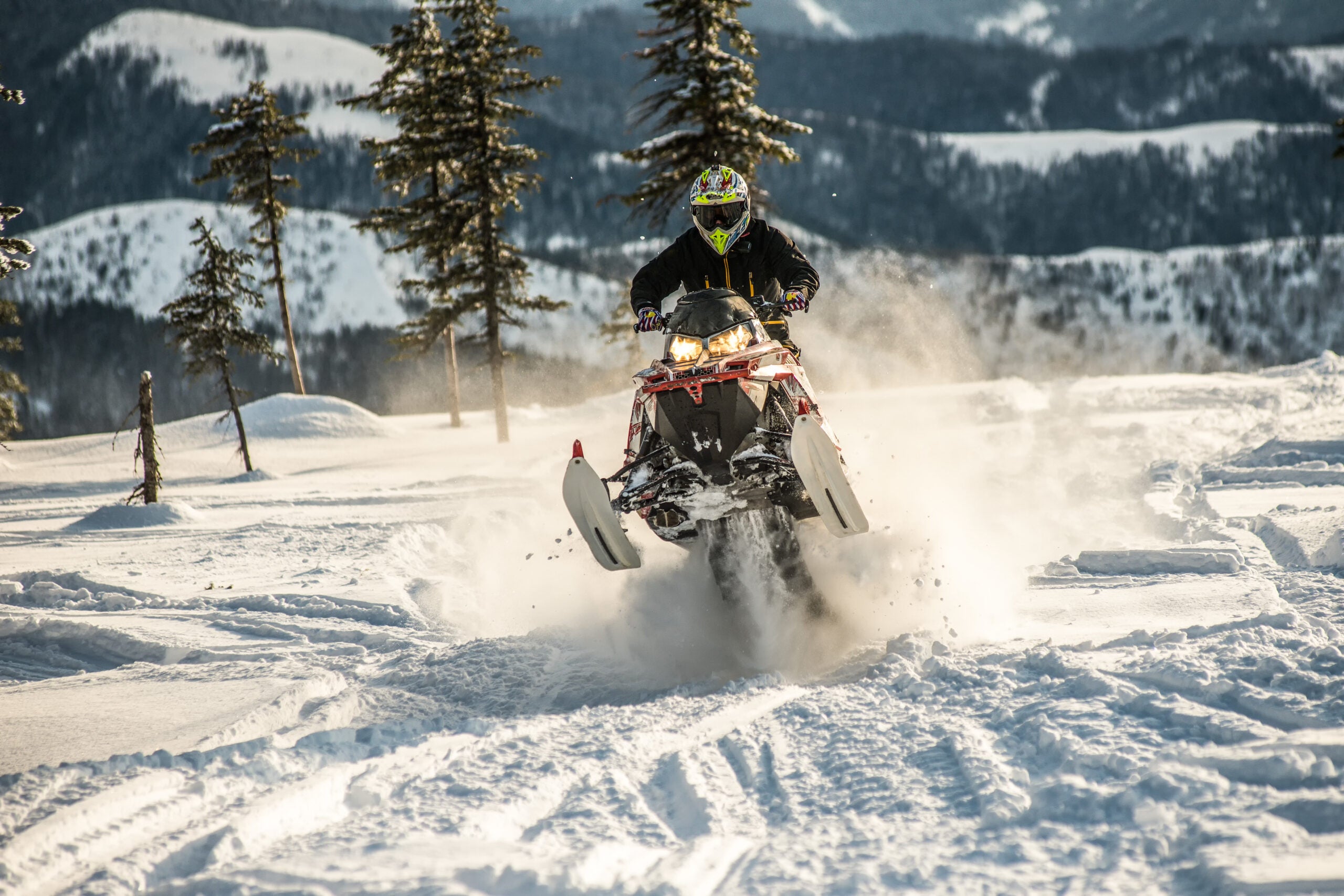 Rider on the snowmobile in the mountains ski resort
