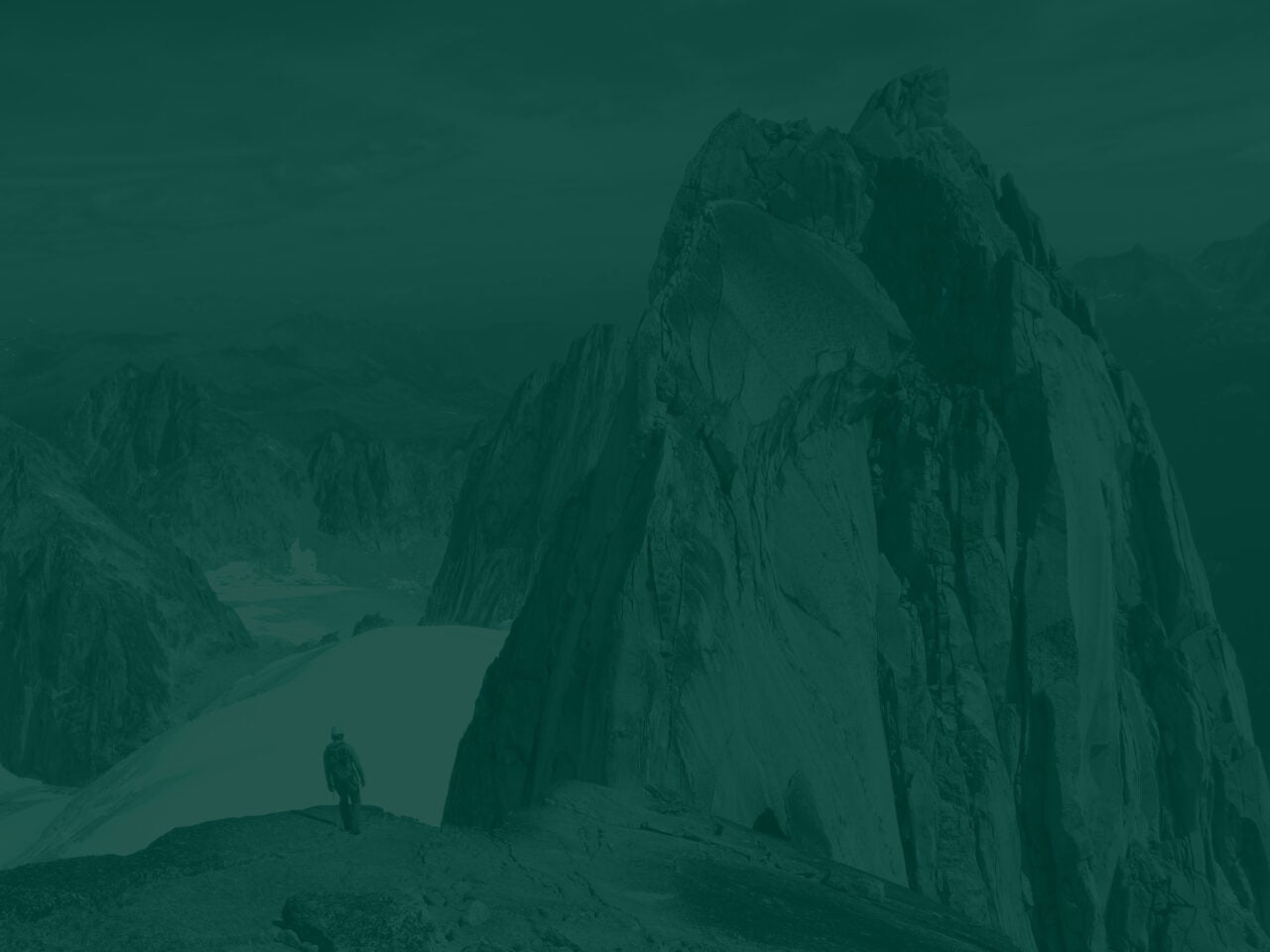 Hiker among snow capped mountains