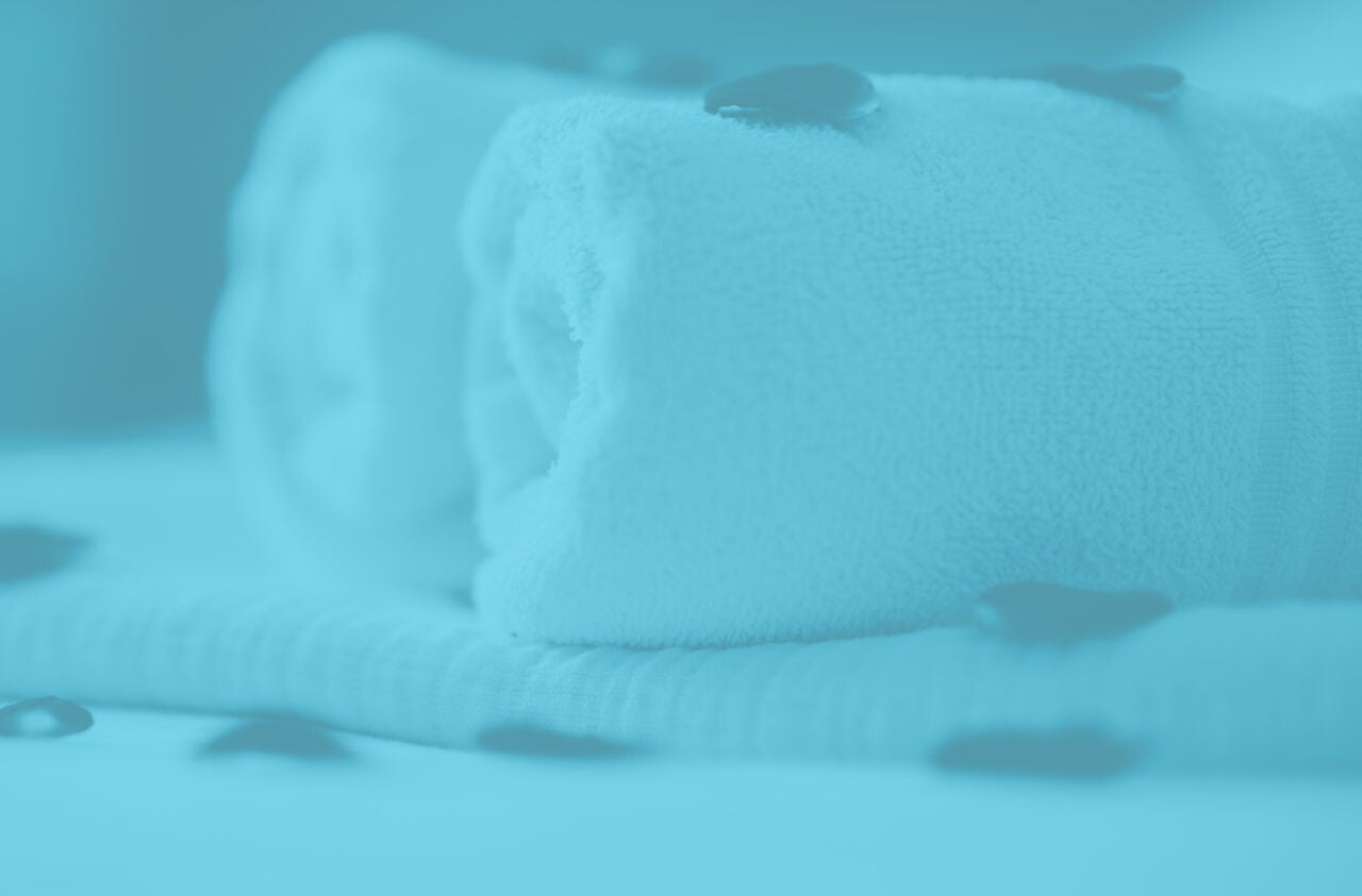 Closeup of white towels rolled up