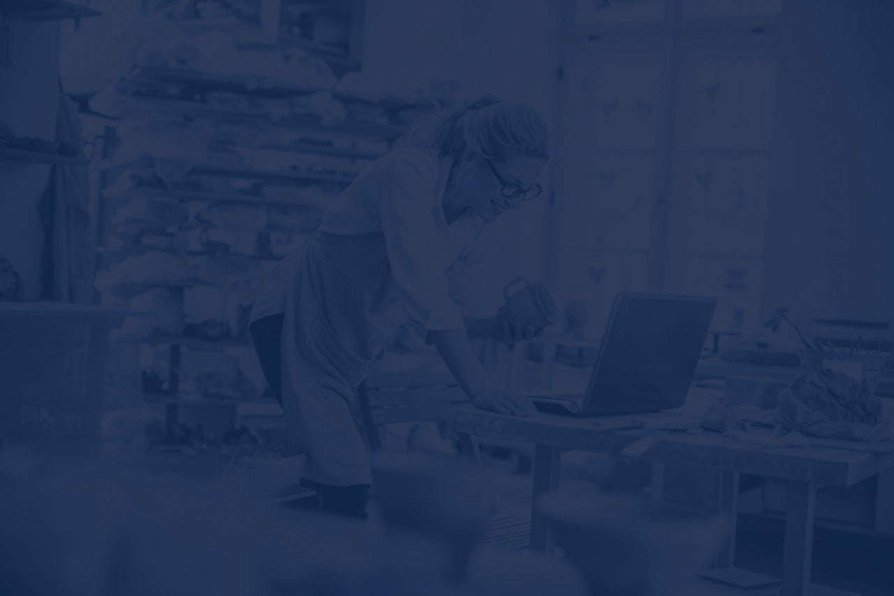 Entrepreneur using laptop in workshop