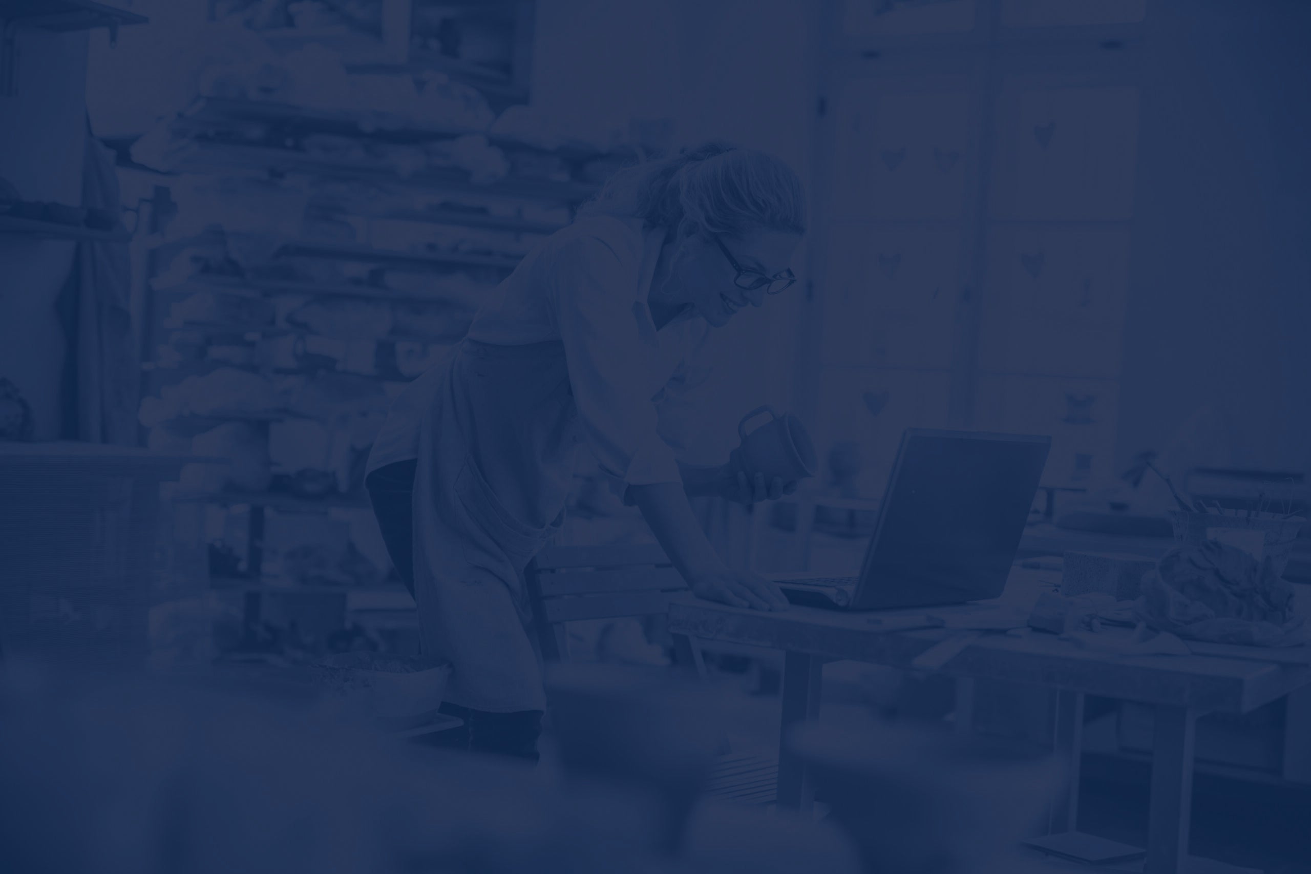 Entrepreneur using laptop in workshop